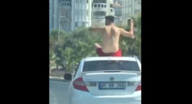 Kuşadası'nda otomobilin üstüne çıkan şahıs yürekleri ağza getirdi